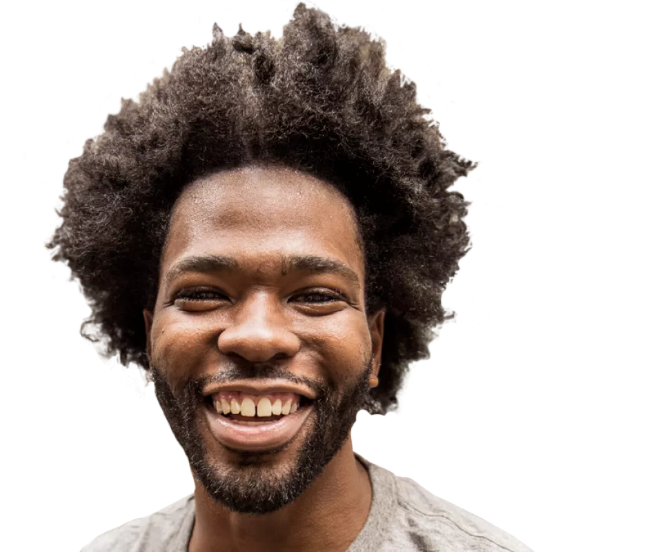 A black man smiling into the camera
