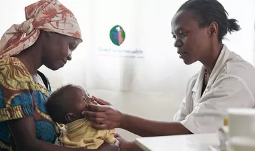 Doctor examining baby in Rwanda