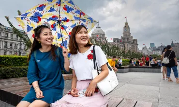 Portrait of two chinese women holding an umbrella