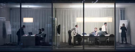 Business people working in a dark room
