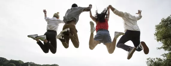 Young adults jumping together