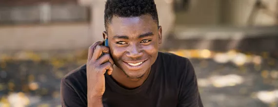 A young black man in South Africa, on the phone 