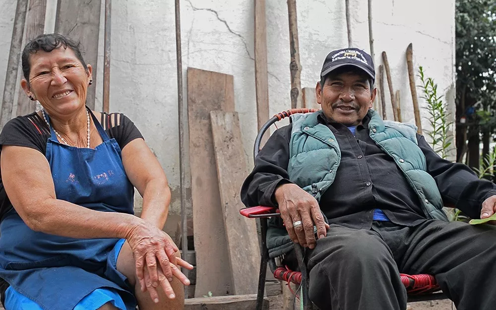 Julia and Felix, a Chagas patient, sitting in front of their home in Bolivia.