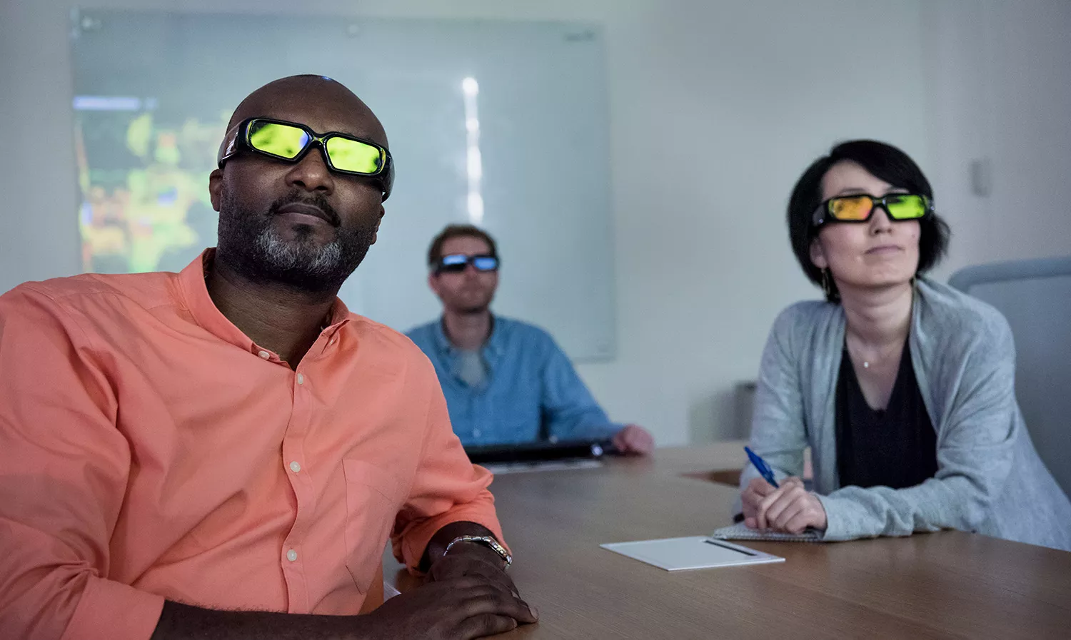 Group of business people watching at a screen using special glasses