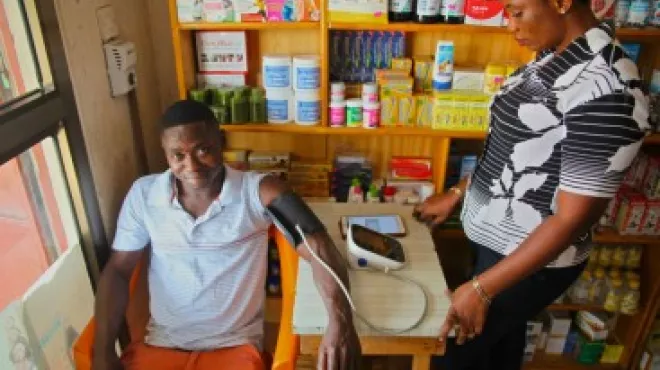 Raphael, 24, got his blood pressure tested when he dropped into a local shop. Shopkeeper Dorothy has been trained to conduct the blood pressure screening.