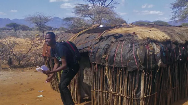 Investigator leaving a hut in Kenya